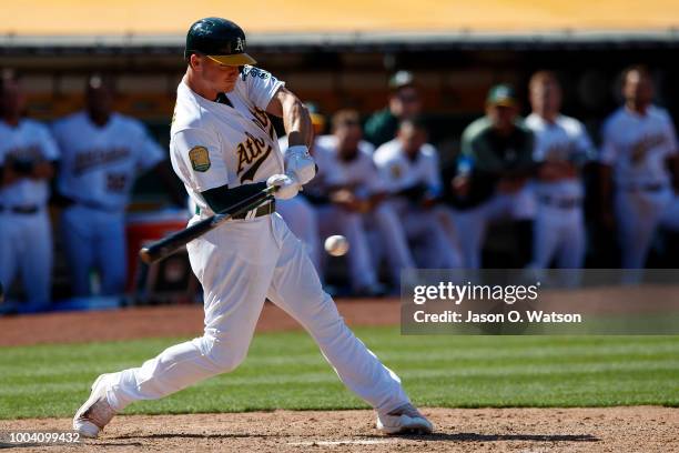 Matt Chapman of the Oakland Athletics hits a walk off RBI single against the San Francisco Giants during the tenth inning at the Oakland Coliseum on...