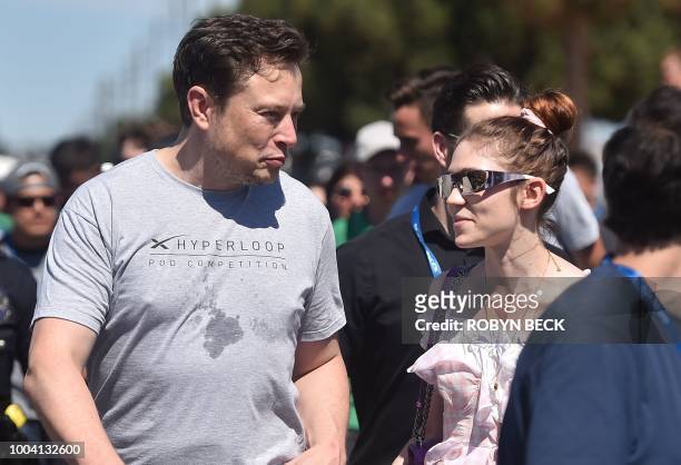 SpaxeX founder Elon Musk and Canadian musician Grimes attend the 2018 Space X Hyperloop Pod Competition, in Hawthorne, California on July 22, 2018. -...