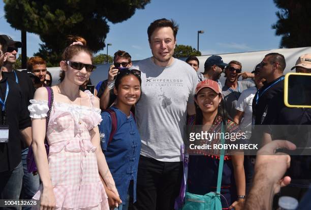SpaxeX founder Elon Musk and Canadian musician Grimes pose for a snapshot with two attendees at the 2018 Space X Hyperloop Pod Competition, in...