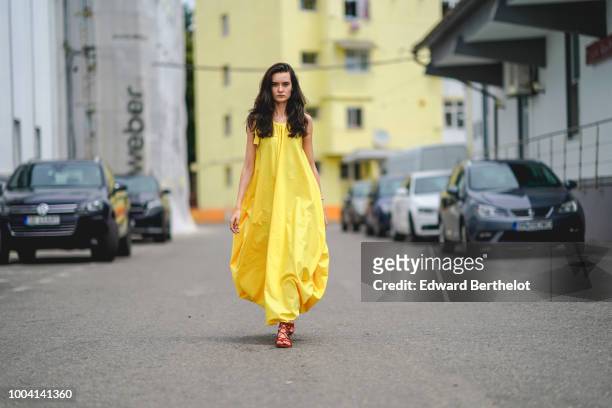 Model wears a yellow dress , during Feeric Fashion Week 2018, on July 22, 2018 in Sibiu, Romania.