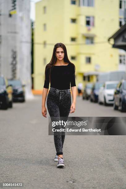 Model wears a black top, gray pants, sneakers , during Feeric Fashion Week 2018, on July 22, 2018 in Sibiu, Romania.