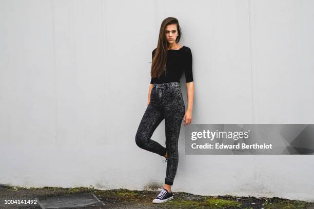 Model wears a black top, gray pants, sneakers , during Feeric Fashion Week 2018, on July 22, 2018 in Sibiu, Romania.