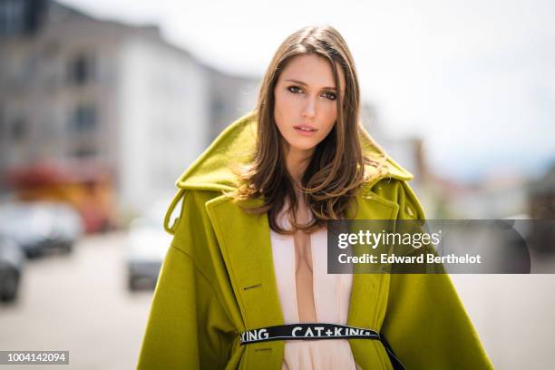 Landiana Cerciu, Vice President of Feeric Fashion Week, wears a green coat and a pink lace ruffled dress , during Feeric Fashion Week 2018, on July...