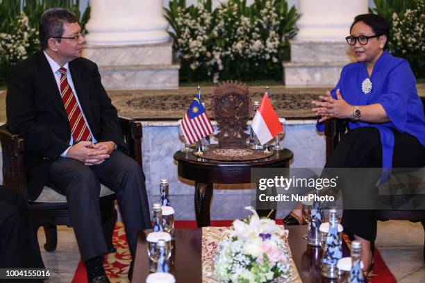 Indonesia's Foreign Minister Retno Marsudi talks to Malaysian Foreign Minister Saifuddin Abdullah during a bilateral meeting in Jakarta, Indonesia on...