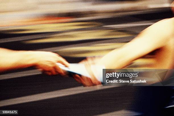 baton handoff in grainy effect - stafett bildbanksfoton och bilder