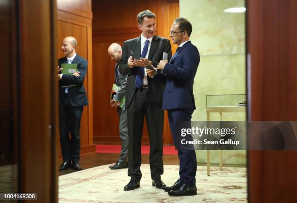 British Foreign Secretary Jeremy Hunt and German Foreign Minister Heiko Maas chat before addressing the media at the Foreign Ministry on July 23,...