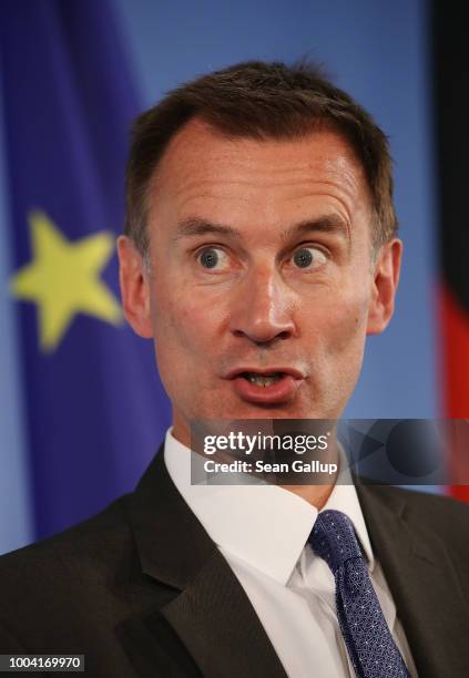 British Foreign Secretary Jeremy Hunt stands next to a flag of the Euopean Union as he and German Foreign Minister Heiko Maas speak to the media at...