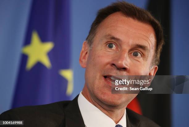 British Foreign Secretary Jeremy Hunt stands next to a flag of the Euopean Union as he and German Foreign Minister Heiko Maas speak to the media at...