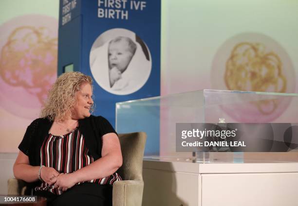 Louise Brown, who in 1978 became the world's first baby to be born following successful in vitro fertilisation , looks at a glass desiccator, a jar...