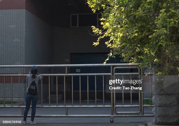 Woman takes photos out of Changchun Changsheng Bio-tech Co, on July 23, 2018 in Changchun, China. The company was found fabricating production...