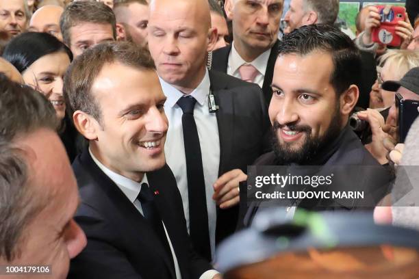 French president Emmanuel Macron flanked by Elysee senior security officer Alexandre Benalla visits the 55th International Agriculture Fair at the...