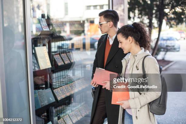 student looking at a bookstore window - book shop exterior stock pictures, royalty-free photos & images