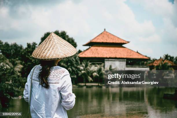 female in traditional clothing visiting beautiful tourist resort by the river - straw hat stock pictures, royalty-free photos & images