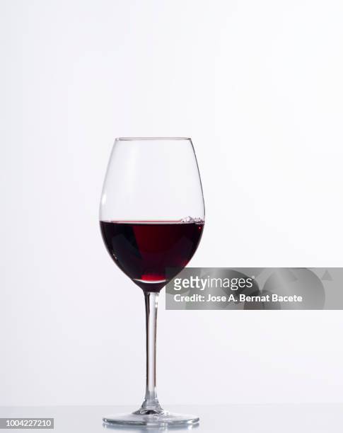 red wine  in glass in front of white background - red wine glass stock pictures, royalty-free photos & images