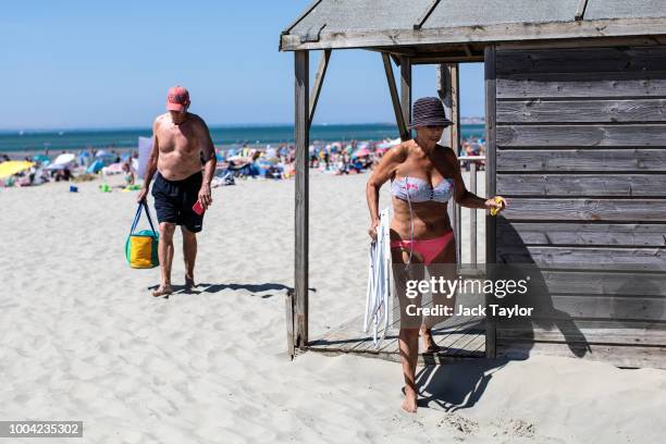 Beachgoers gather on West Wittering Beach during hot weather on the first day of the Summer school holidays on July 23, 2018 in Chichester, England....