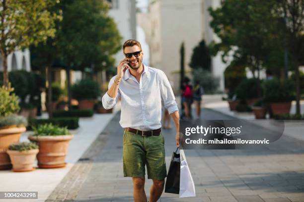 young elegant man in the city - men shopping stock pictures, royalty-free photos & images