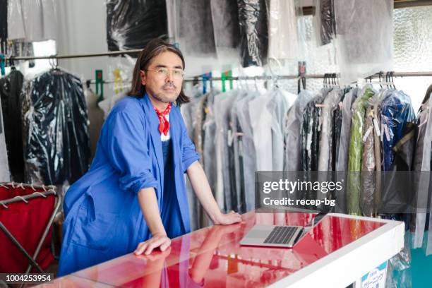 portrait of dry cleaning shop owner - dry cleaners stock pictures, royalty-free photos & images