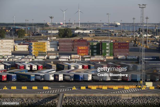 Shipping containers and cargo trucks stand on the dockside at the Port of Zeebrugge in Zeebrugge, Belgium, on Wednesday, July 18, 2018. The European...