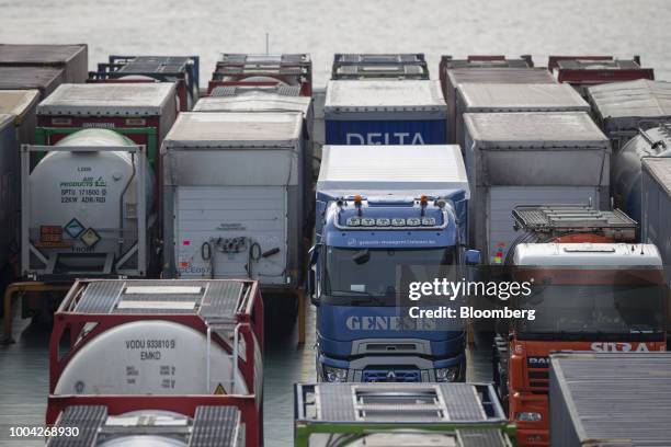 Cargo and tanker trucks sit on the upper deck of roll-on roll-off vessel Delphine, operated by Cldn Ro-Ro SA, as it arrives at the Port of...