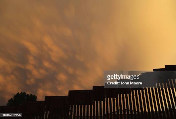 The U.S.-Mexico border fence is seen at sunset on July 22, 2018 in Nogales, Arizona. President Trump has proposed replacing the fence with a wall.