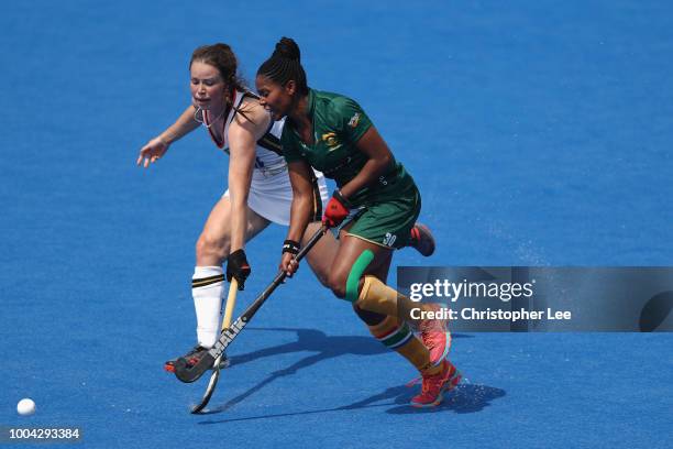 Sulette Damons of South Africa takes on Amelie Wortmann of Germany during the Pool C game between Germany and South Africa of the FIH Womens Hockey...