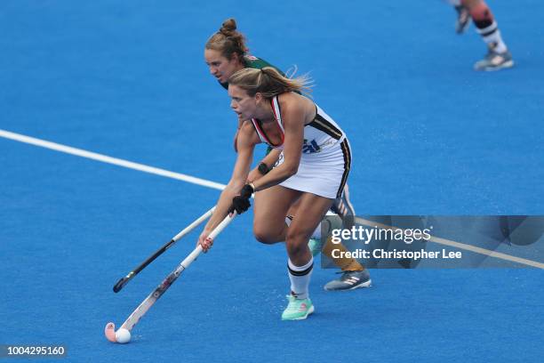 Anne Schroder of Germany battles with Kristen Paton of South Africa during the Pool C game between Germany and South Africa of the FIH Womens Hockey...