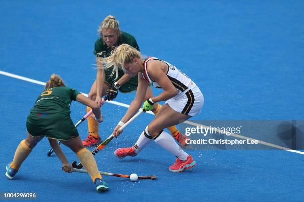 Hannah Gablac of Germany battls with Simone Gouws of South Africa and Shelley Jones of South Africa during the Pool C game between Germany and South...