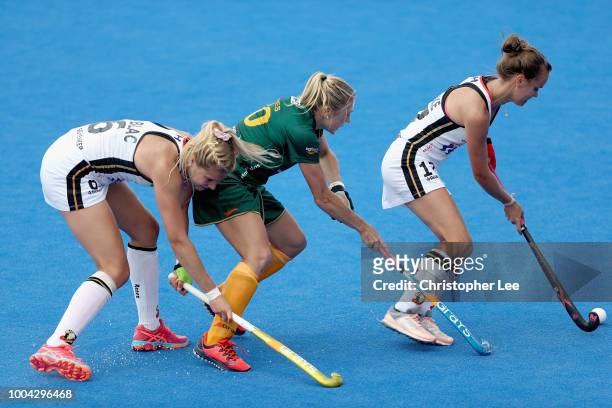 Hannah Gablac of Germany, Shelley Jones of South Africa and Jana Teschke of Germany battle for the ball during the Pool C game between Germany and...