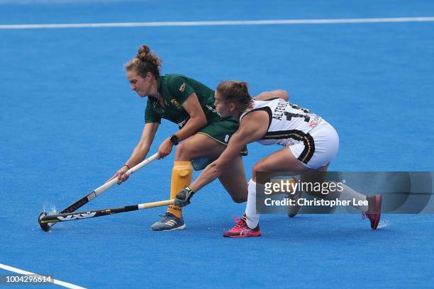 Kristen Paton of South Africa battles with Lisa Altenburg of Germany during the Pool C game between Germany and South Africa of the FIH Womens Hockey...