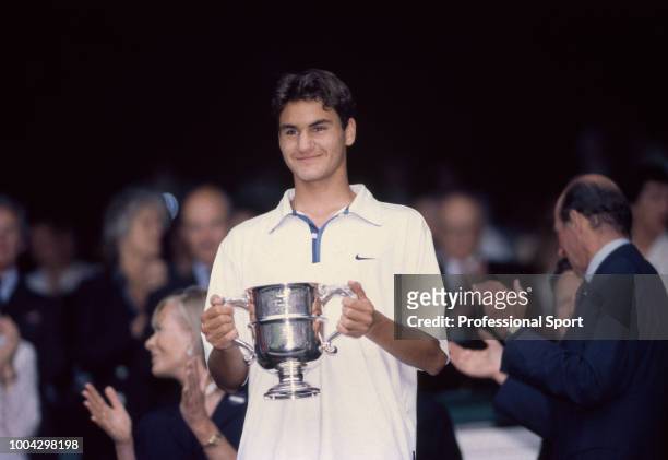 Roger Federer of Switzerland poses with the trophy after defeating Irakli Labadze of Georgia in the Boys' Singles Final of the Wimbledon Lawn Tennis...