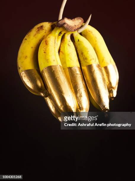 bananas dipped in gold - meal expense stock pictures, royalty-free photos & images