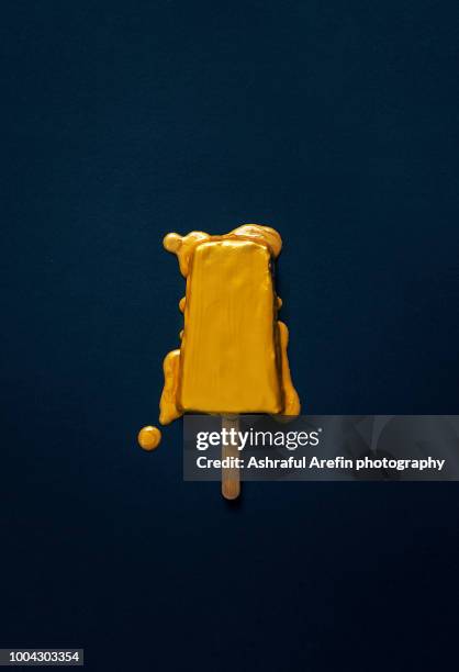 gold melting popsicle - gold concept stock-fotos und bilder