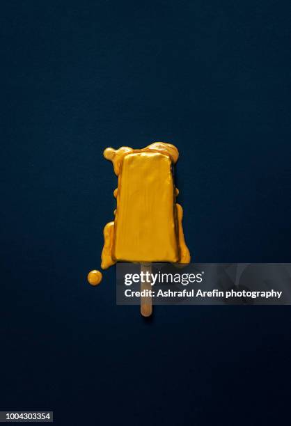 gold melting popsicle - meal expense stock pictures, royalty-free photos & images