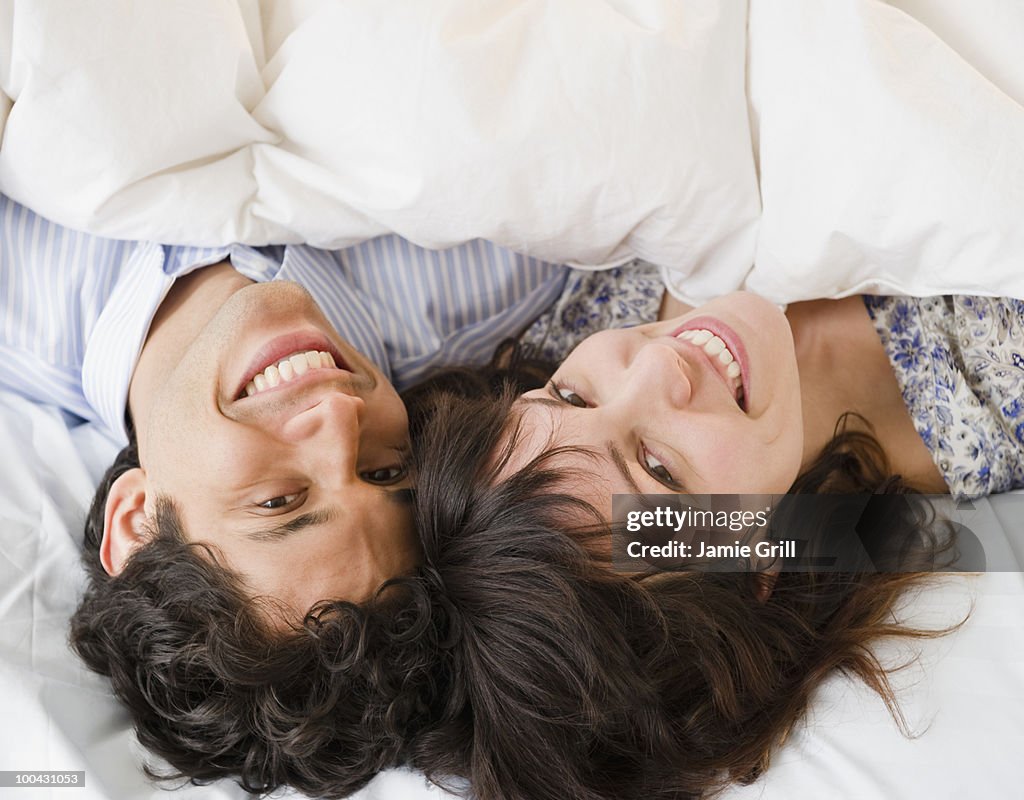 Young couple relaxing in bed