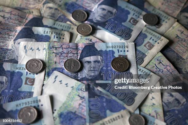 pakistani one thousand rupee banknotes and coins - rupee stock pictures, royalty-free photos & images