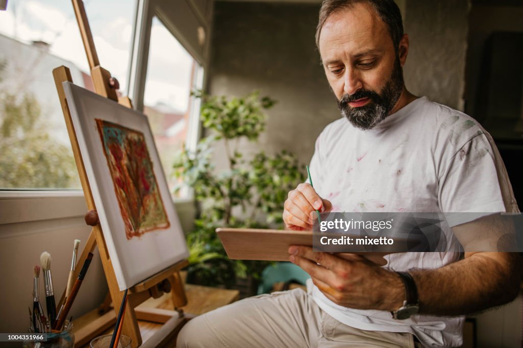 Mature artist on his art studio