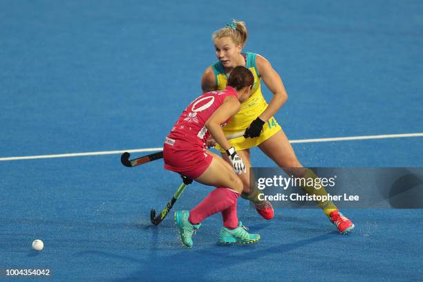 Stephanie Kershaw of Australia cuts around Minami Shimizu of Japan during the Pool D game between Australia and Japan of the FIH Womens Hockey World...