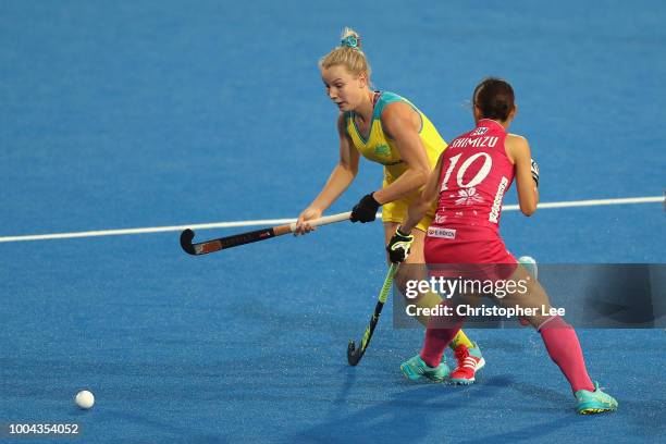 Stephanie Kershaw of Australia cuts around Minami Shimizu of Japan during the Pool D game between Australia and Japan of the FIH Womens Hockey World...