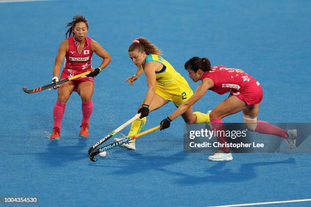 Ambrosia Malone of Australia battles with Mayumi of Japan and Yukari Mano of Japan during the Pool D game between Australia and Japan of the FIH...