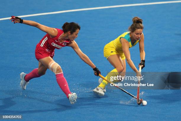 Brooke Peris of Australia battles with Mayumi of Japan during the Pool D game between Australia and Japan of the FIH Womens Hockey World Cup at Lee...