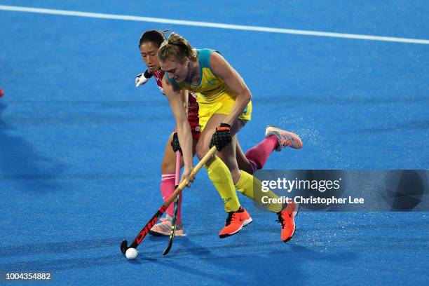 Emily Hurtz of Australia battles with Miki Kozuka of Japan during the Pool D game between Australia and Japan of the FIH Womens Hockey World Cup at...