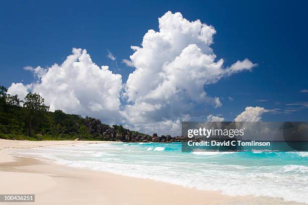 clouds above grand anse, la digue, seychelles - cumulonimbus fotografías e imágenes de stock