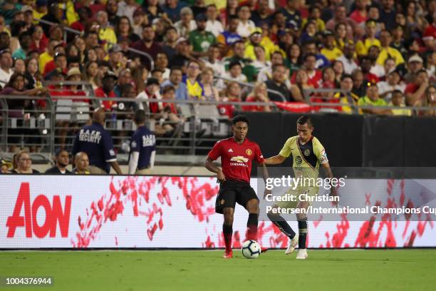 Demitri Mitchell of Manchester United moves the ball past Paul Aguilar of Club America during the International Champions Cup game at the University...