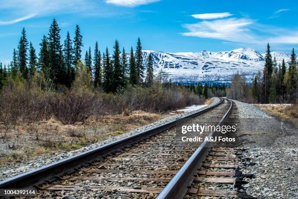 railroad track and mountain range - alaska location stock pictures, royalty-free photos & images