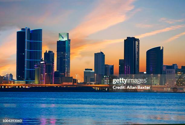 skyline of the diplomatic quarter of manama at twilight - bahrain skyline stock pictures, royalty-free photos & images