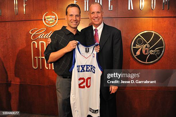 Doug Collins poses for a photo with his son Chris Collins after being named the new coach of the Philadelphia 76ers during the press conference on...