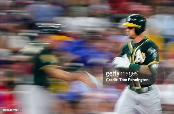 Stephen Piscotty of the Oakland Athletics celebrates after hitting a two-run home run in the top of the fifth inning against the Texas Rangers at...