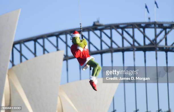 The Grinch hangs outside a helicopter above the Harbour Bridge and Opera House on July 24, 2018 in Sydney, Australia. As Australians celebrate...