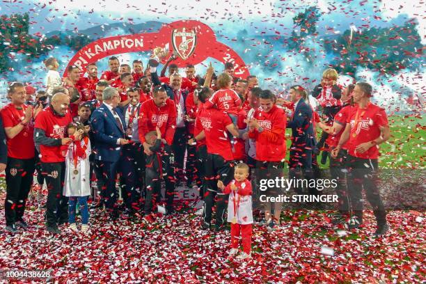 This picture taken on May 23, 2018 shows Skenderbeu's players and KF Skenderbeu president Ardian Takaj , celebrating after wining the cup of the 79th...