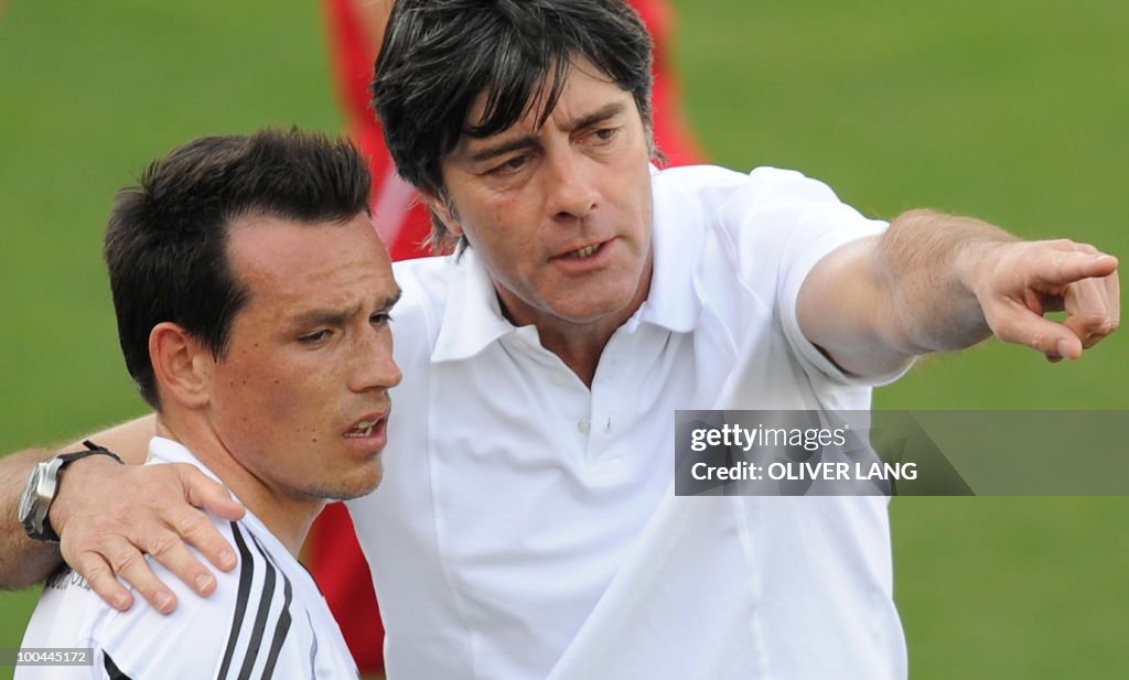 Germany's head coach Joachim Loew (R) ta